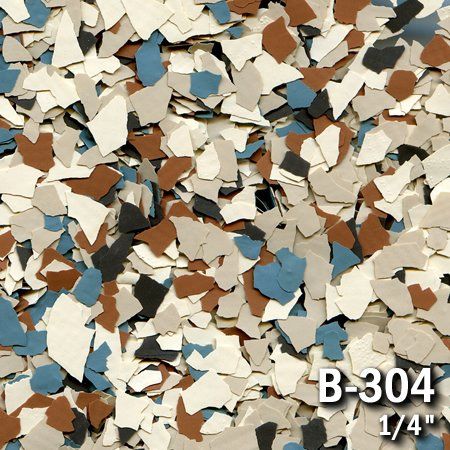 Close-up of decorative floor chips: beige, brown, blue, gray, and black in a random pattern.