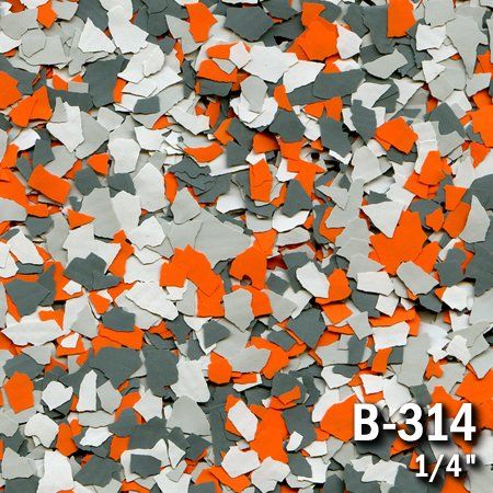Close-up of decorative floor flakes in orange, gray, and white. 