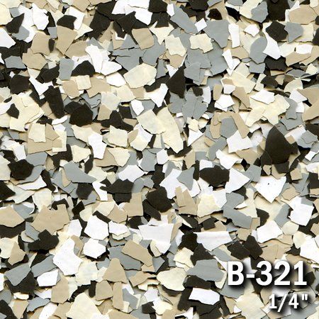Close-up of decorative floor flakes in beige, gray, white, and black.