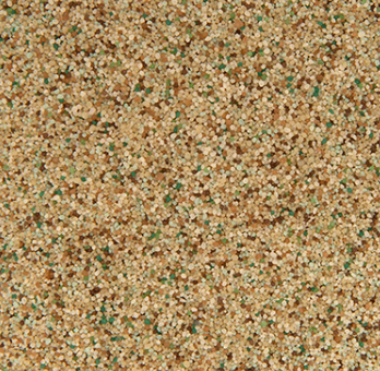 Close-up view of textured aggregate, tan and beige with scattered green flecks.