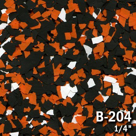 Close-up of a speckled flooring surface with black, orange, and white chips. The label reads 