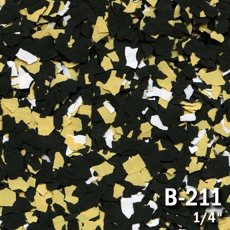 Close-up of decorative floor chips: black, gold, and white. 