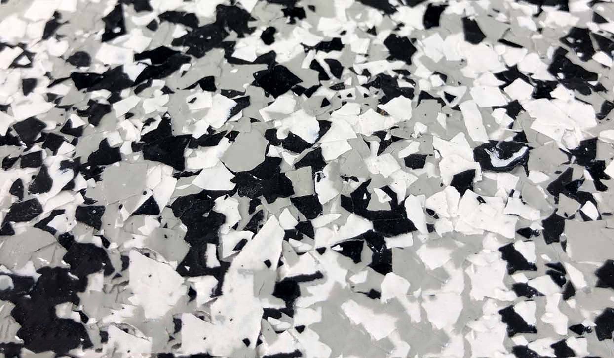 Close-up of a speckled floor with black, gray, and white chips.