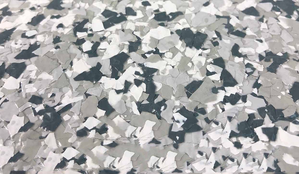 Gray, white, and dark blue speckled epoxy flooring.