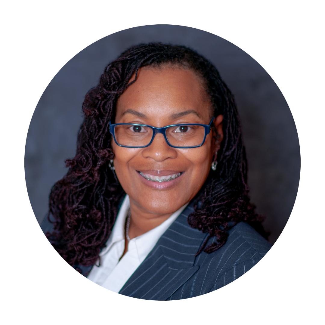 A woman in a suit and tie is smiling in a circle