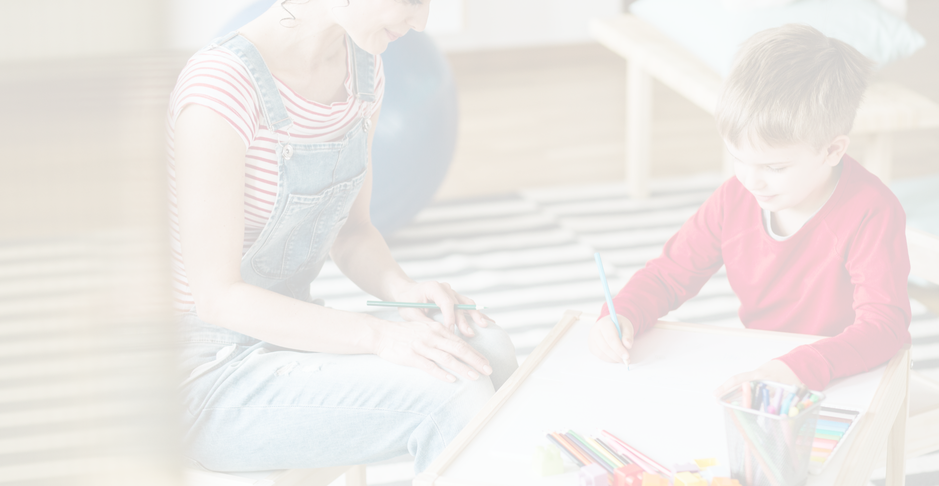 A woman and a child are sitting at a table.