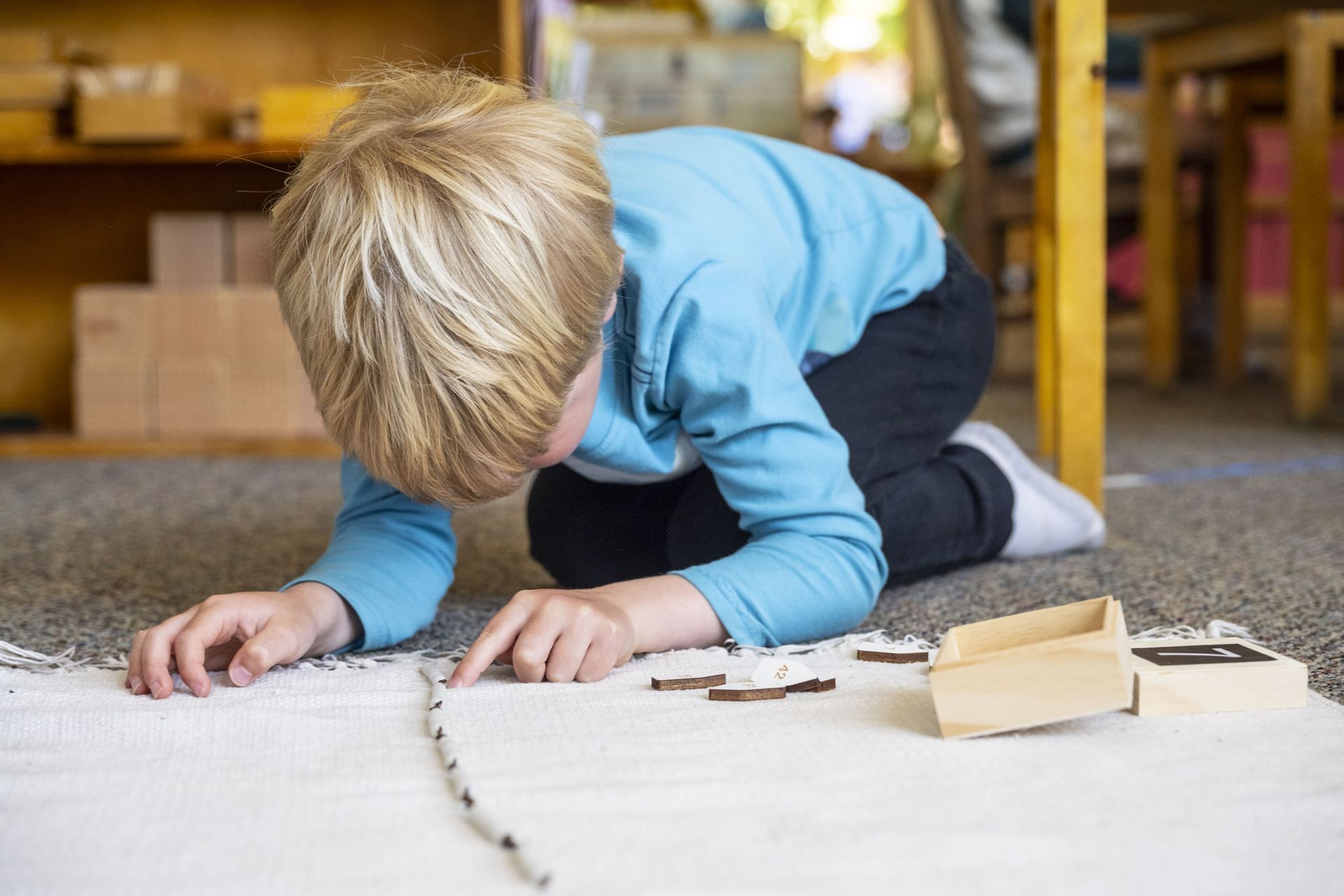 Child working with Montessori math beads