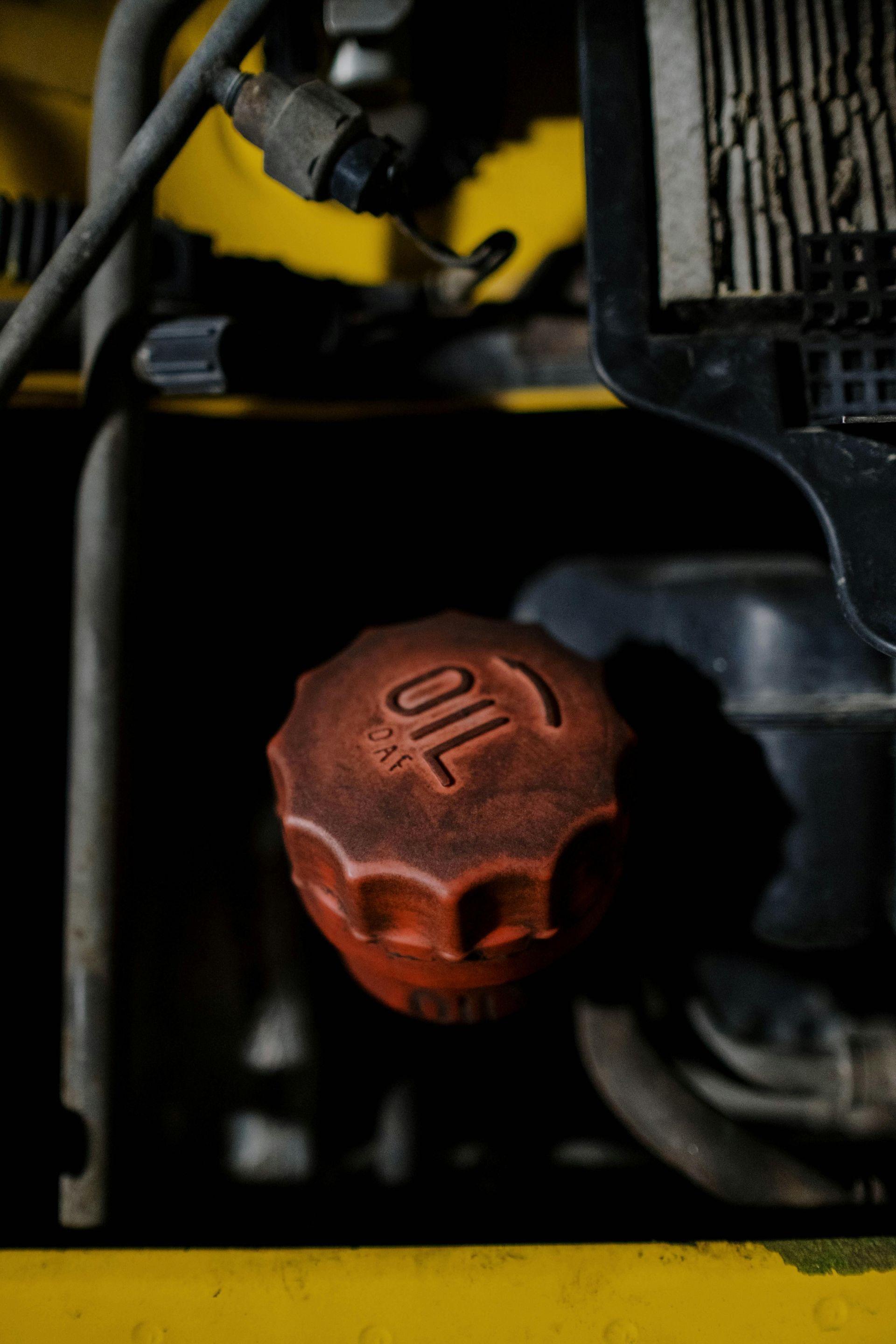 Red oil cap on a yellow machine, 