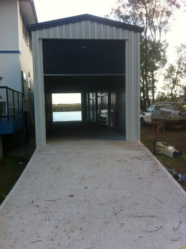 A Garage With A Blue Door Is Being Built Next To A House – South Kempsey NSW - Fair Dinkum Builds Macleay Valley Sheds
