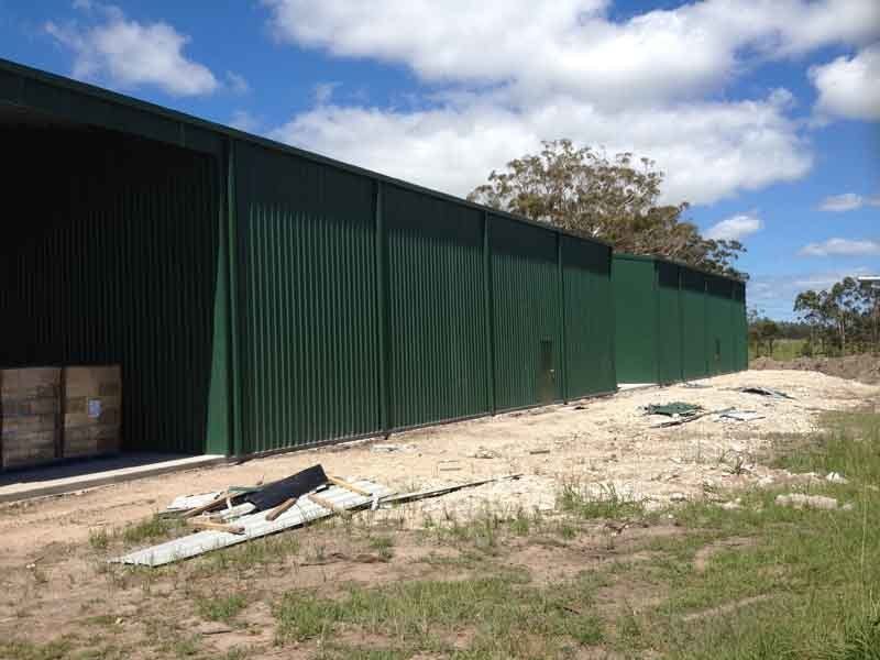 A Large Green Shed Is Sitting In The Middle Of A Field – South Kempsey NSW - Fair Dinkum Builds Macleay Valley Sheds