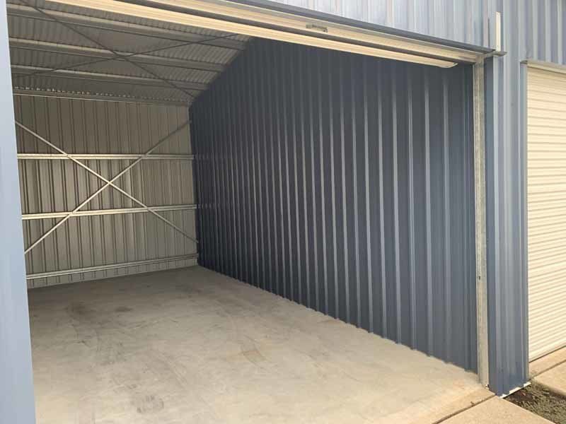 An Empty Garage With A Door Open And A Concrete Floor – South Kempsey NSW - Fair Dinkum Builds Macleay Valley Sheds