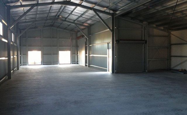 A Large Empty Warehouse With A Concrete Floor – South Kempsey NSW - Fair Dinkum Builds Macleay Valley Sheds