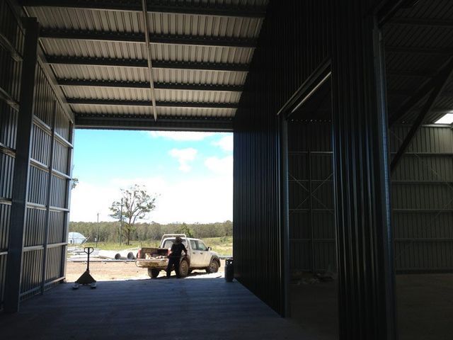 A Truck Is Parked In A Warehouse With The Door Open – South Kempsey NSW - Fair Dinkum Builds Macleay Valley Sheds