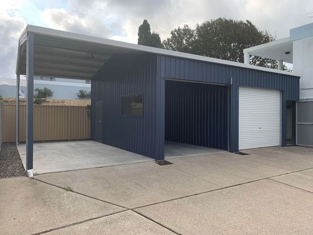 A Blue Garage With A White Door And A Canopy – South Kempsey NSW - Fair Dinkum Builds Macleay Valley Sheds
