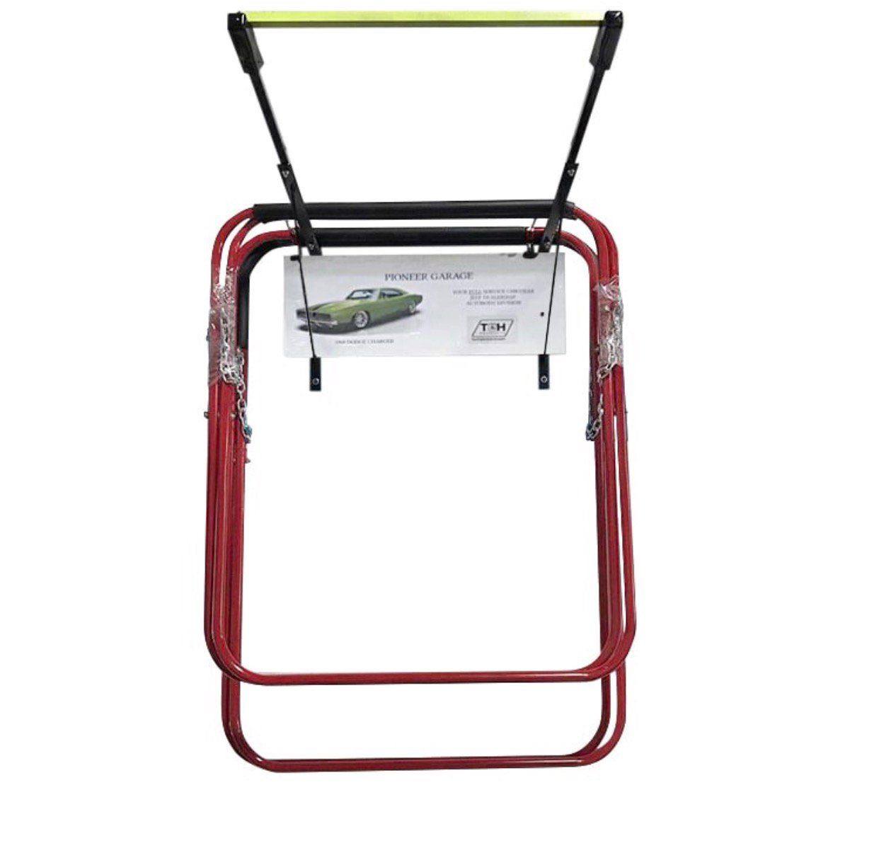 Red vehicle storage lift with black overhead bar, hanging on a white wall.