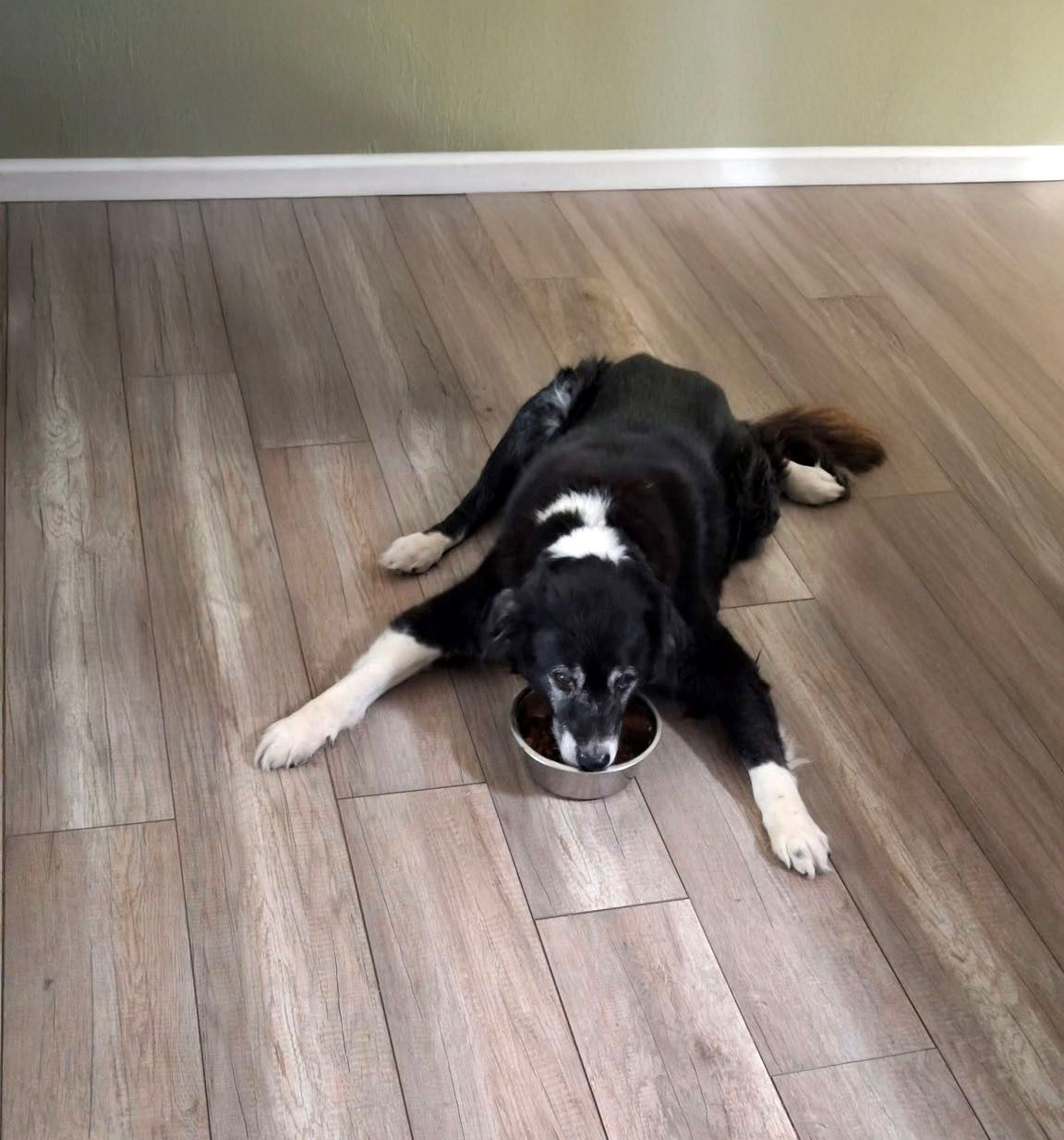A living room with a wooden floor and a window.
