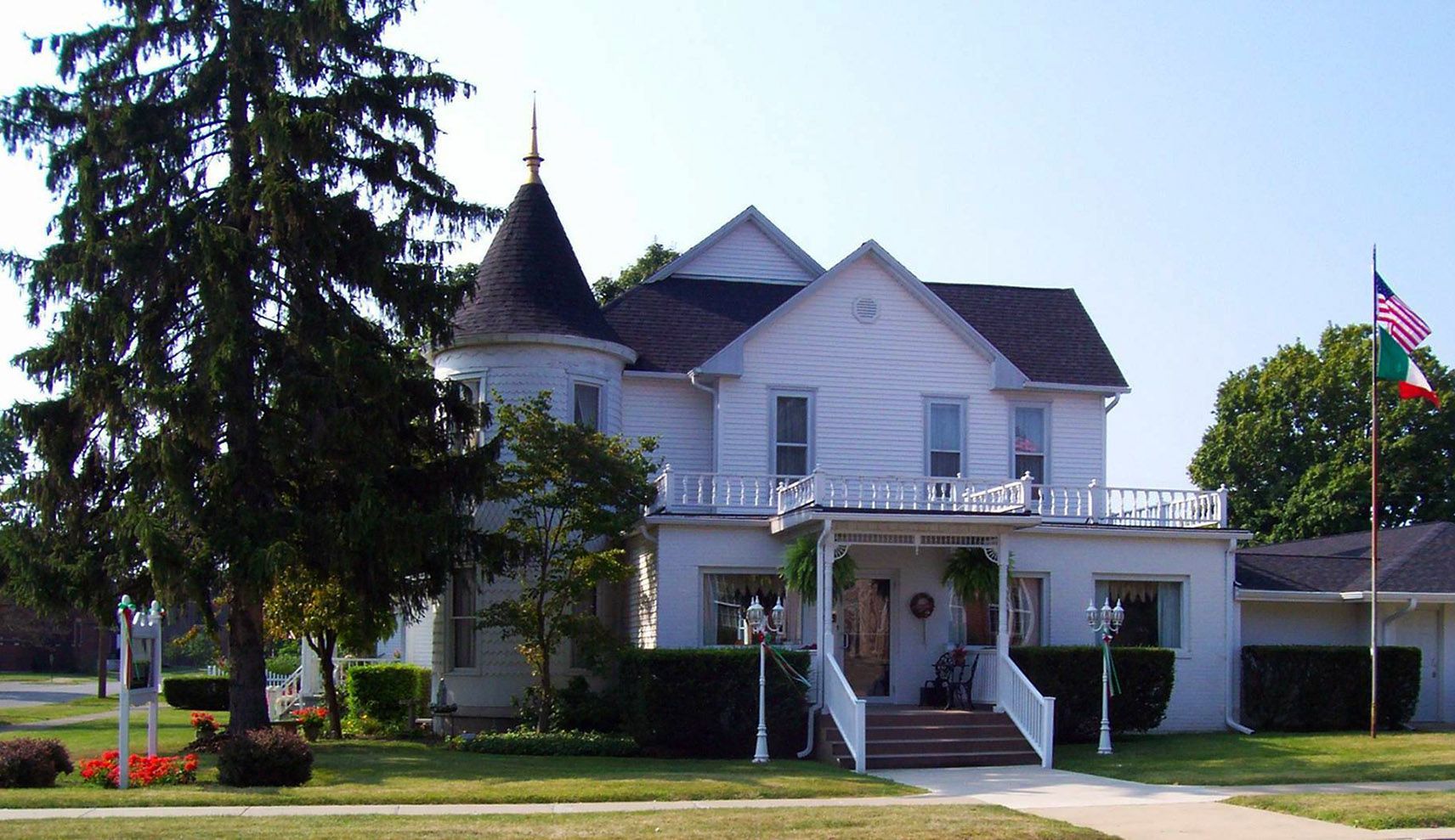 A large white house with a tower on top of it
