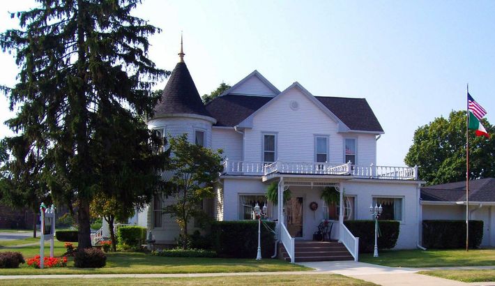 A large white house with a tower on top of it