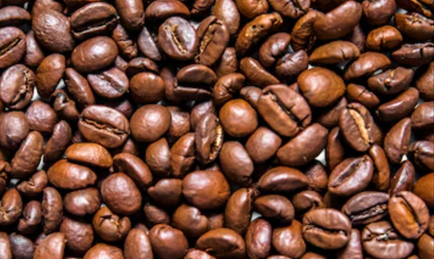 Close-up of roasted coffee beans filling the frame in rich brown tones
