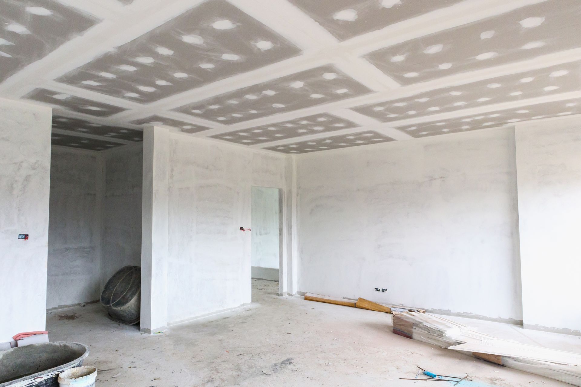 An empty room with a ceiling that is being built.
