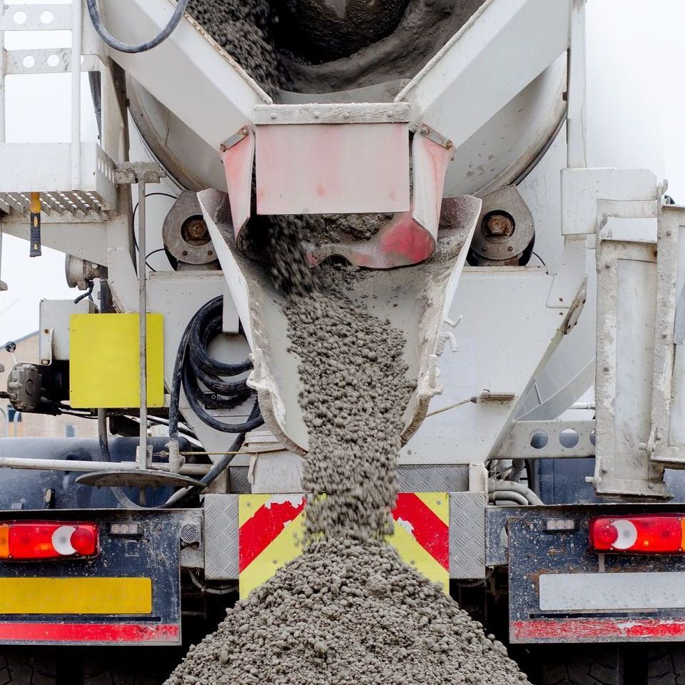 A concrete mixer is pouring concrete into a truck