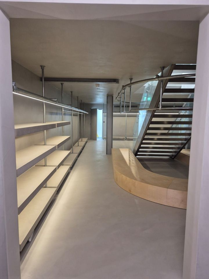 Commercial microcement staircase and floor installation in a modern interior