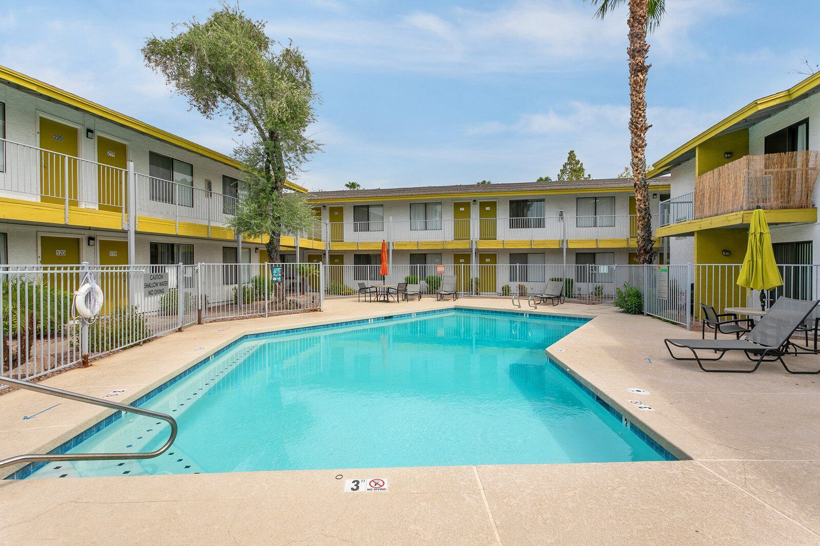 There is a large swimming pool in the middle of a building.