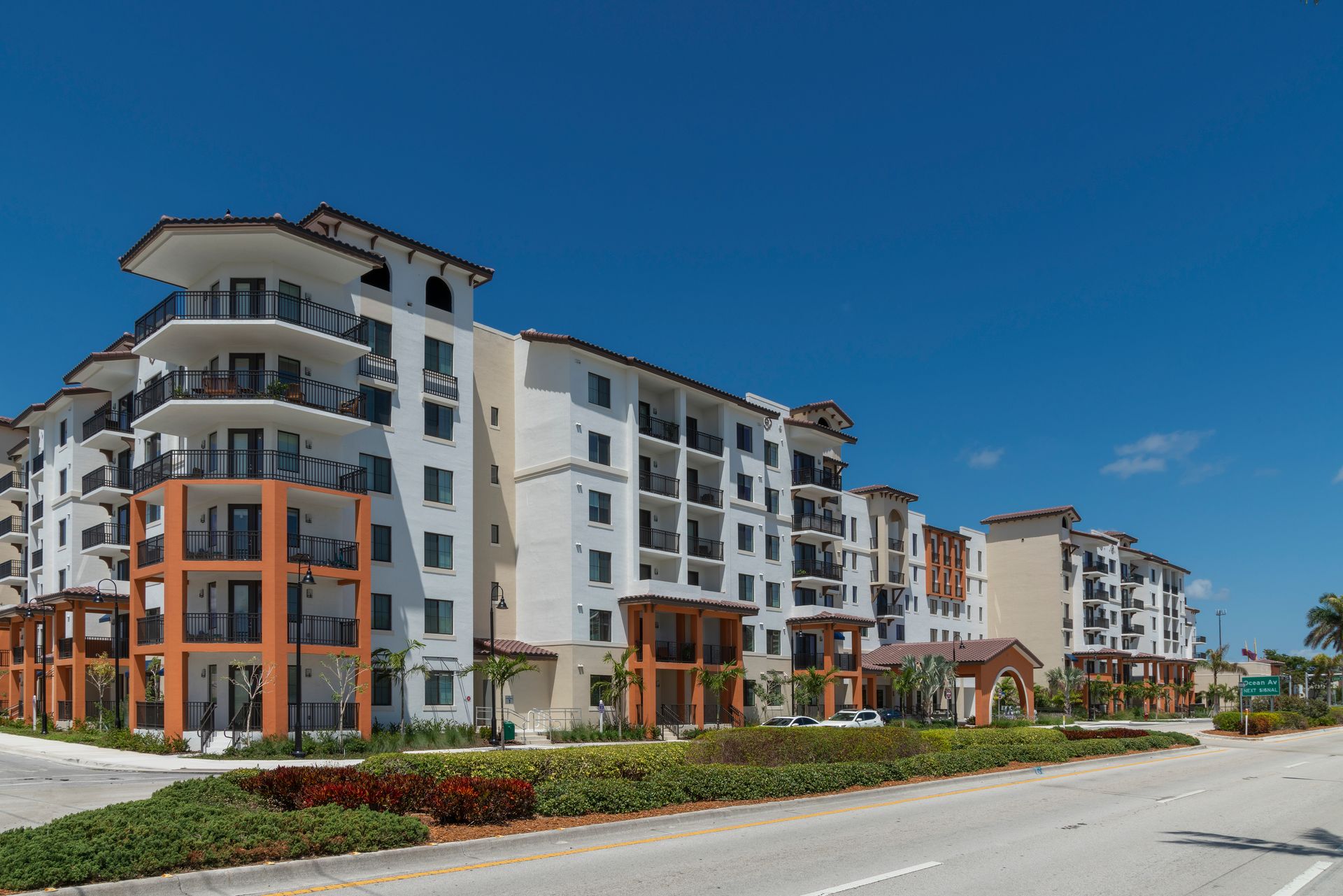 A large apartment building with a lot of balconies on a sunny day
