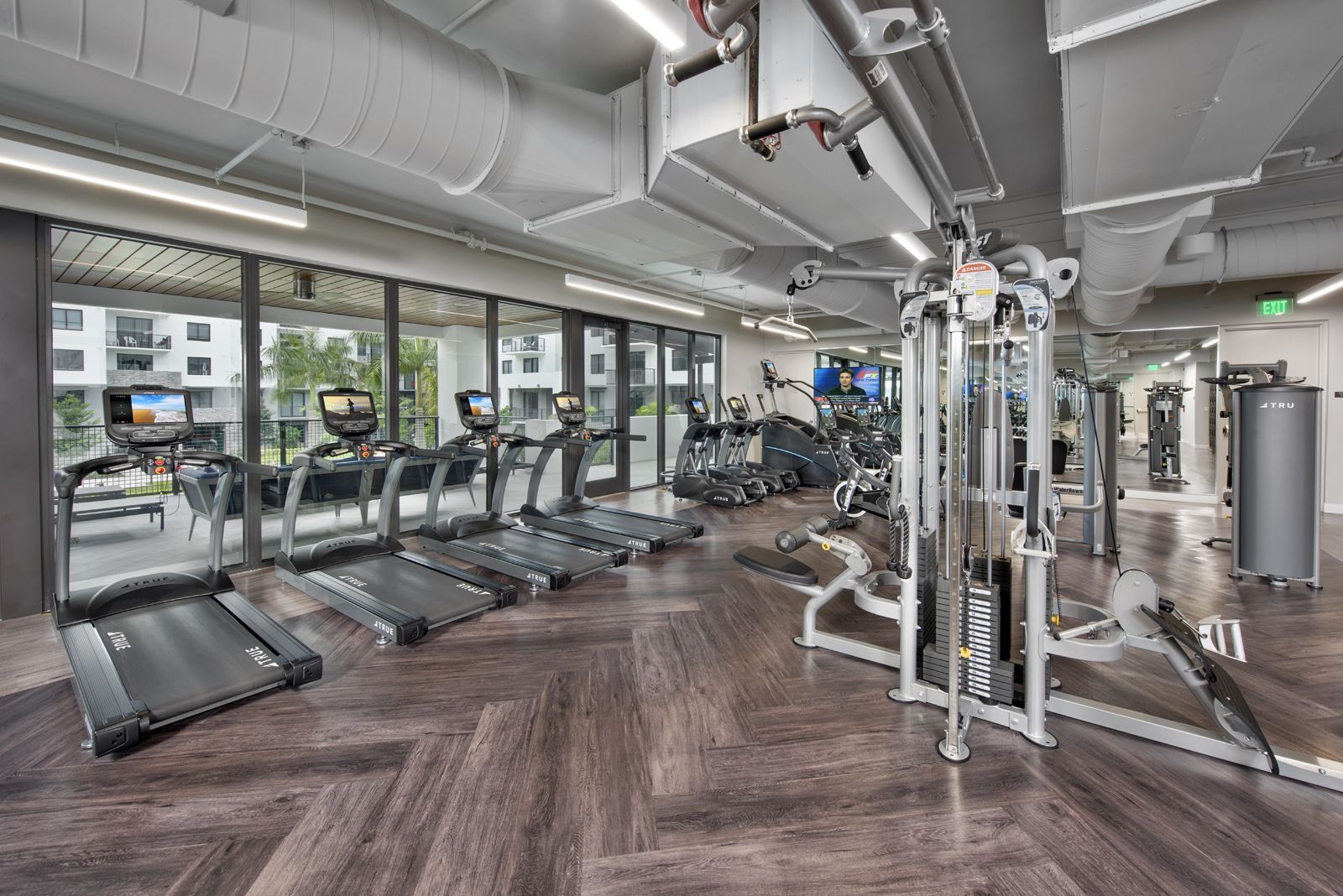 A large gym with a lot of treadmills and exercise equipment.