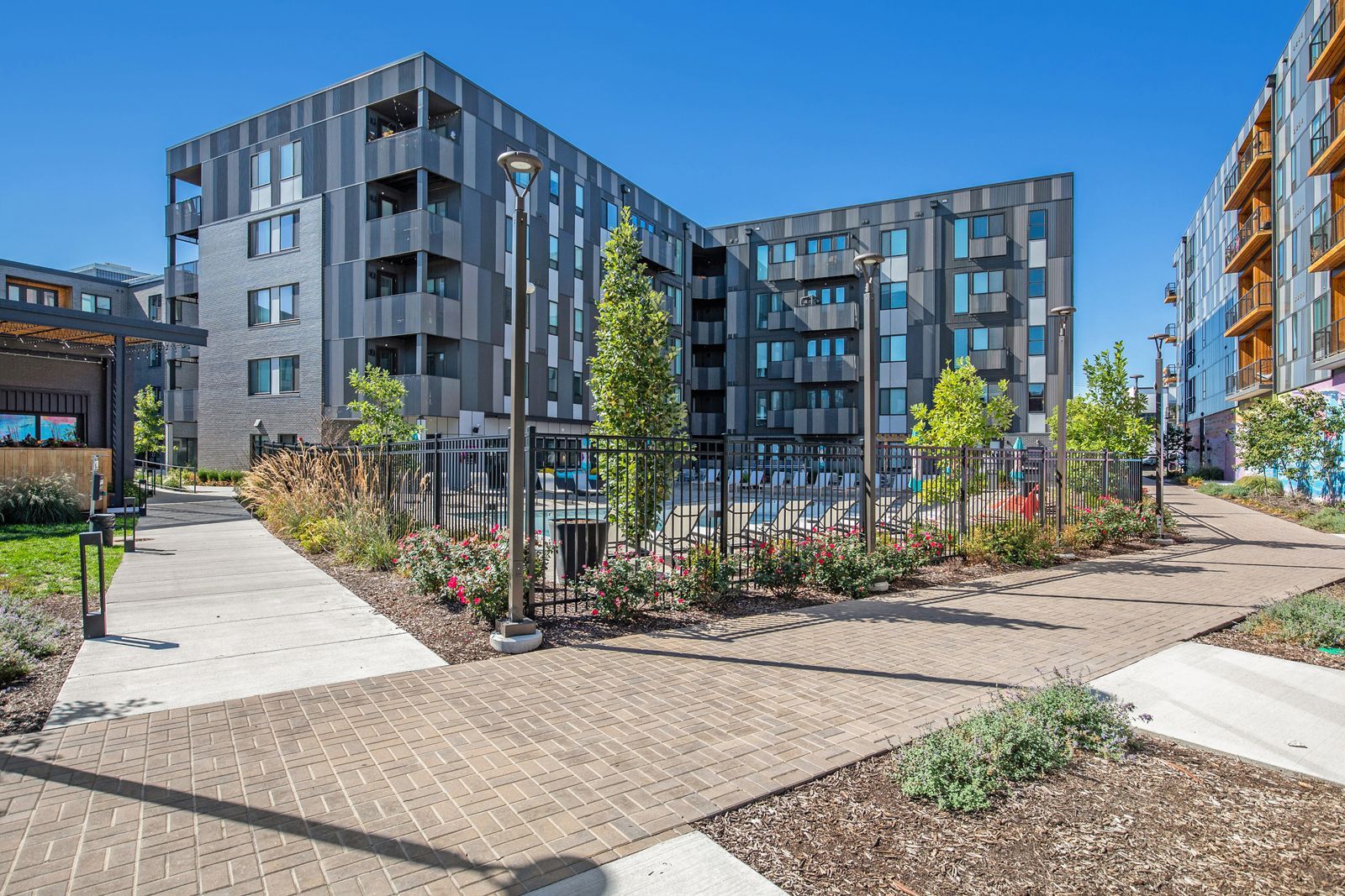 A large apartment building with a walkway leading to it.