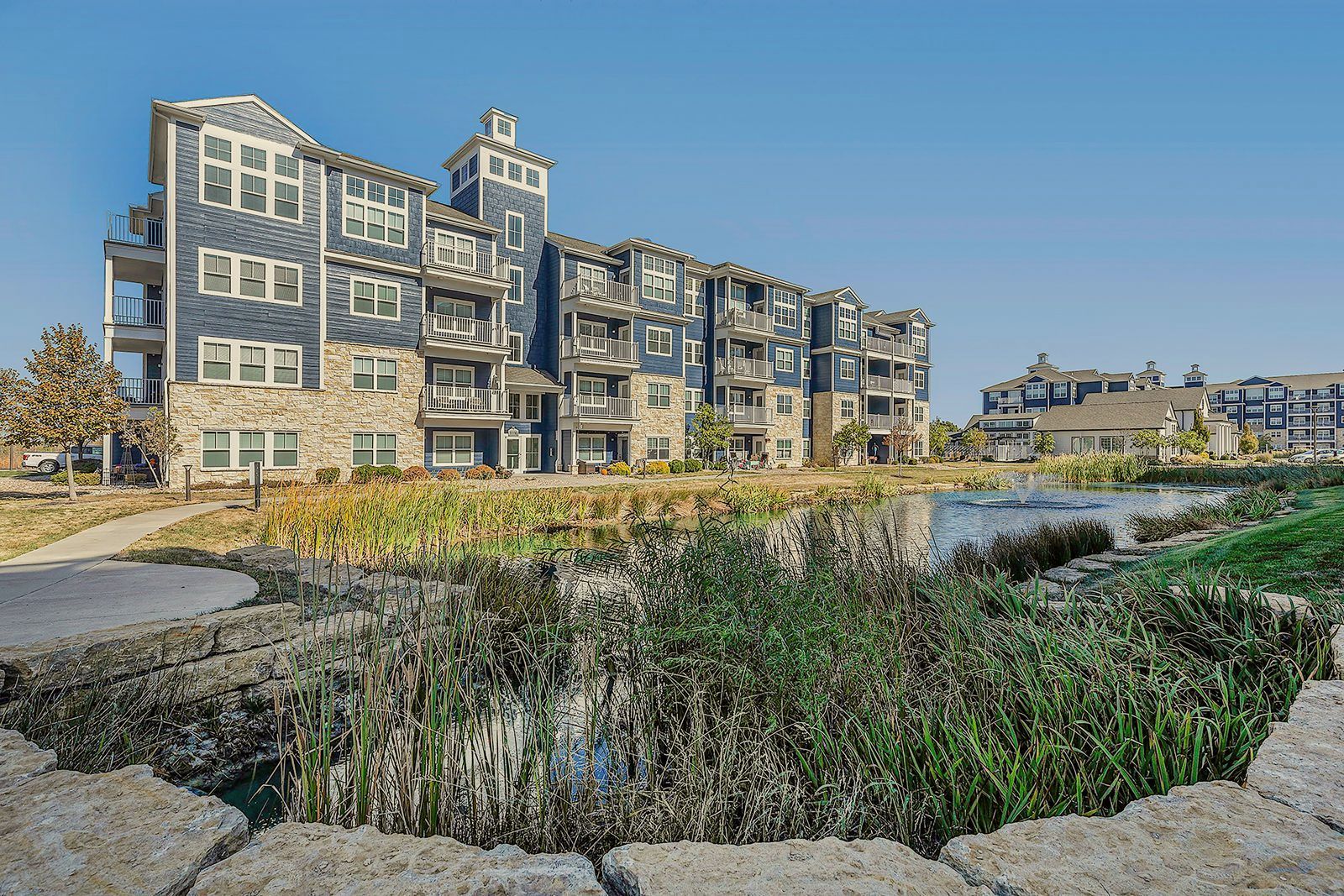 A large building with a pond in front of it.