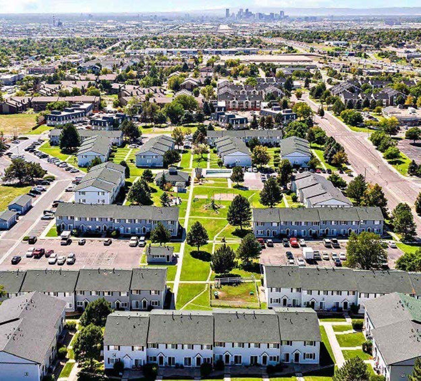 An aerial view of a residential area with a city in the background