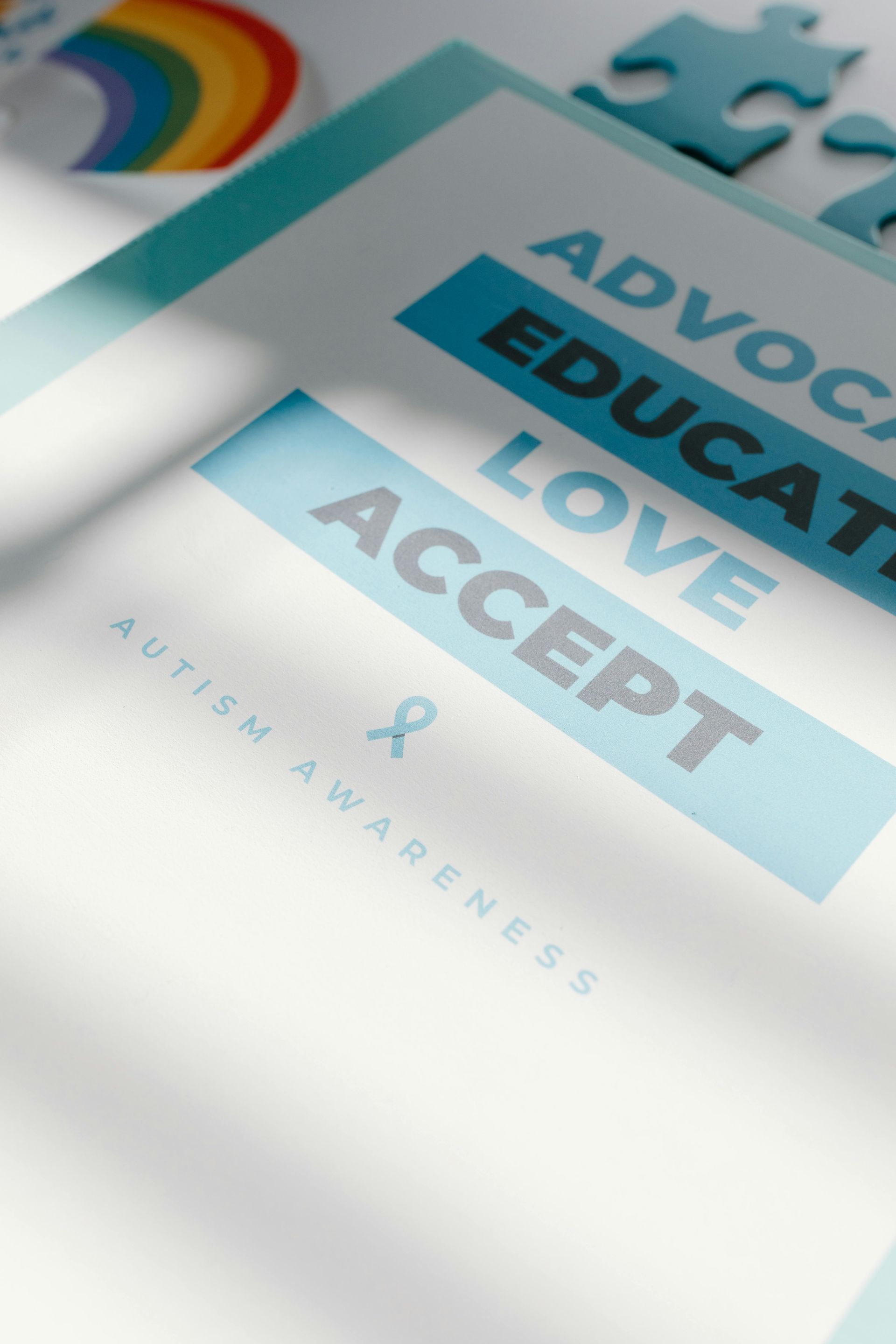 A piece of paper that says advocate educate love accept autism awareness