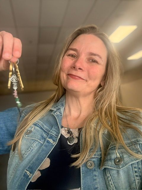 Mandy holding the keys to the new studio