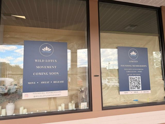 Wild Lotus Movement Coming Soon signs in the storefront windows