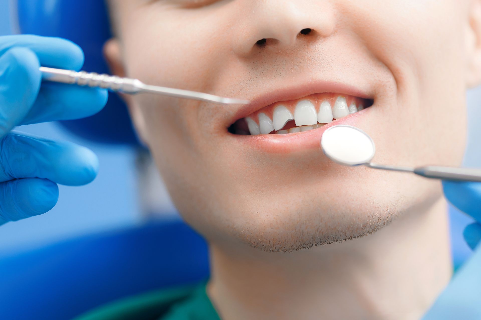 Close-up of a smiling mouth with a finger pulling down the lower lip to show the teeth Close-up of a smiling mouth with a finger pulling down the lower lip to show the teeth