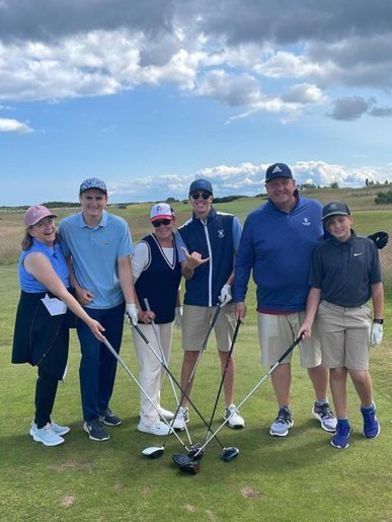 Mixed team playing golf