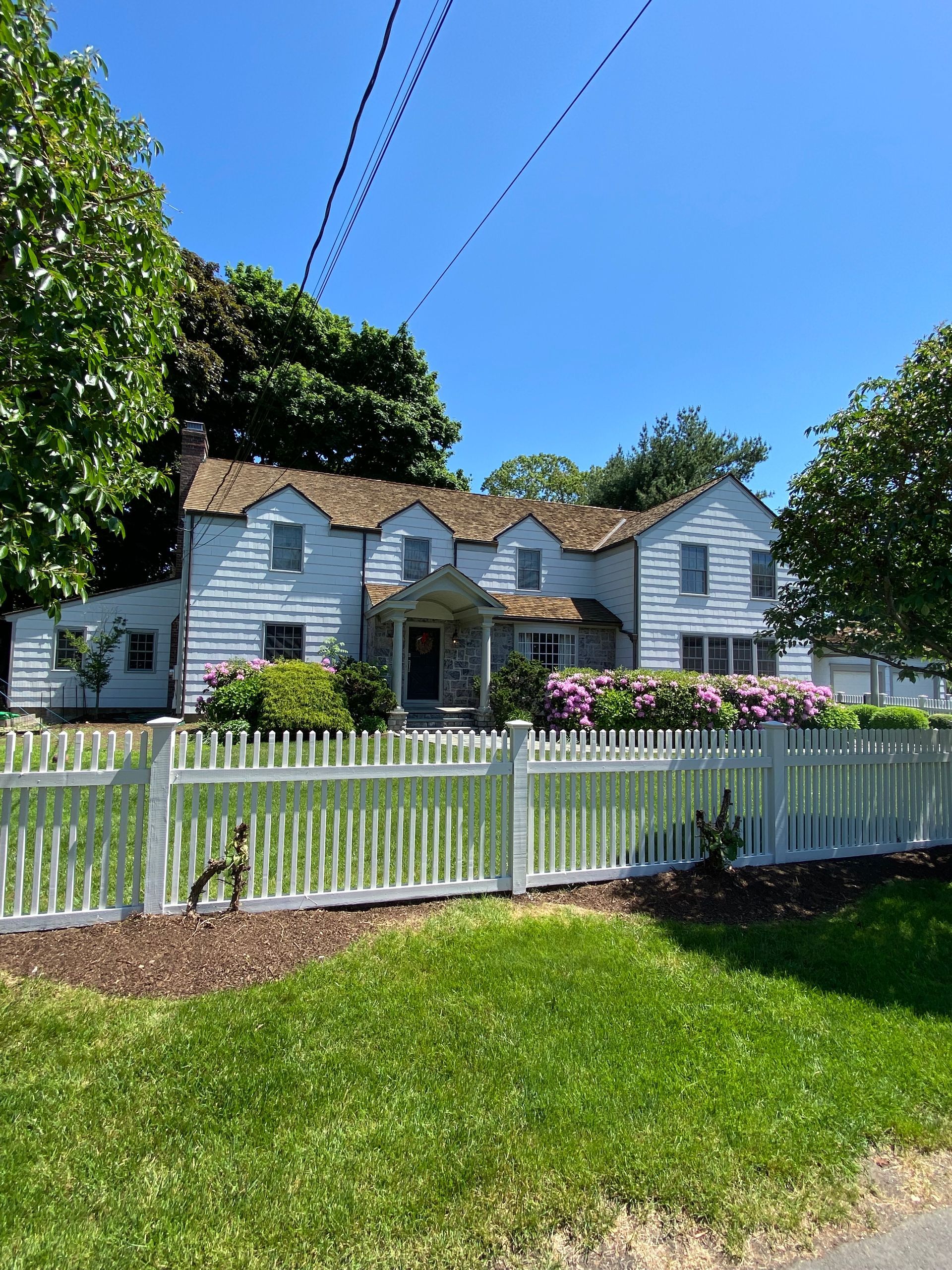 A white house with a white picket fence in front of it