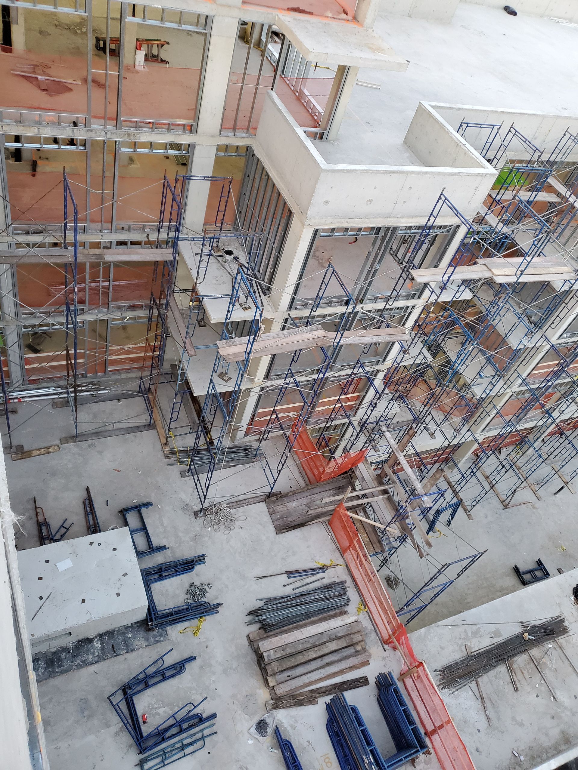 Construction site with scaffolding and building framework.