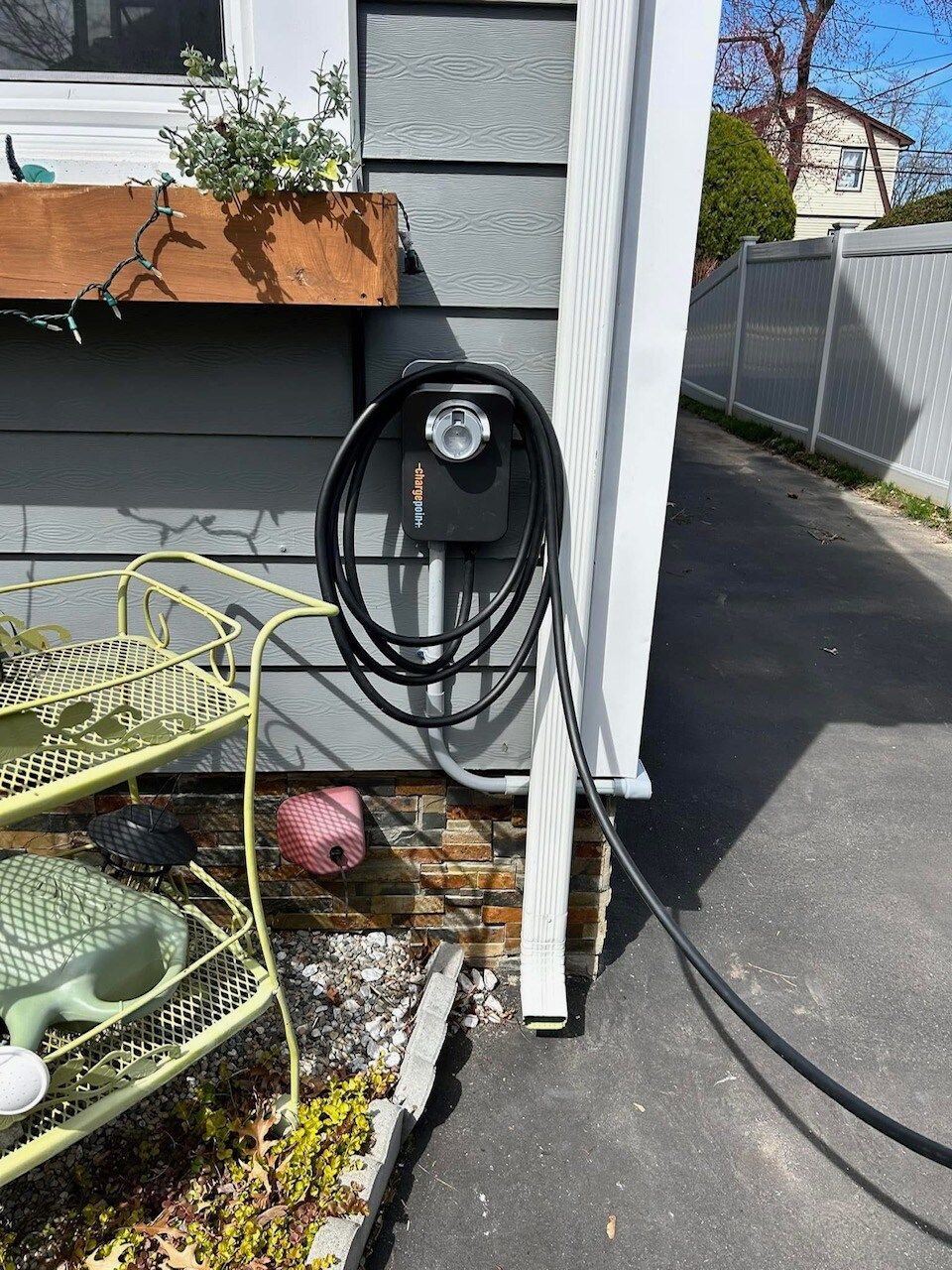 A hose is attached to the side of a house.