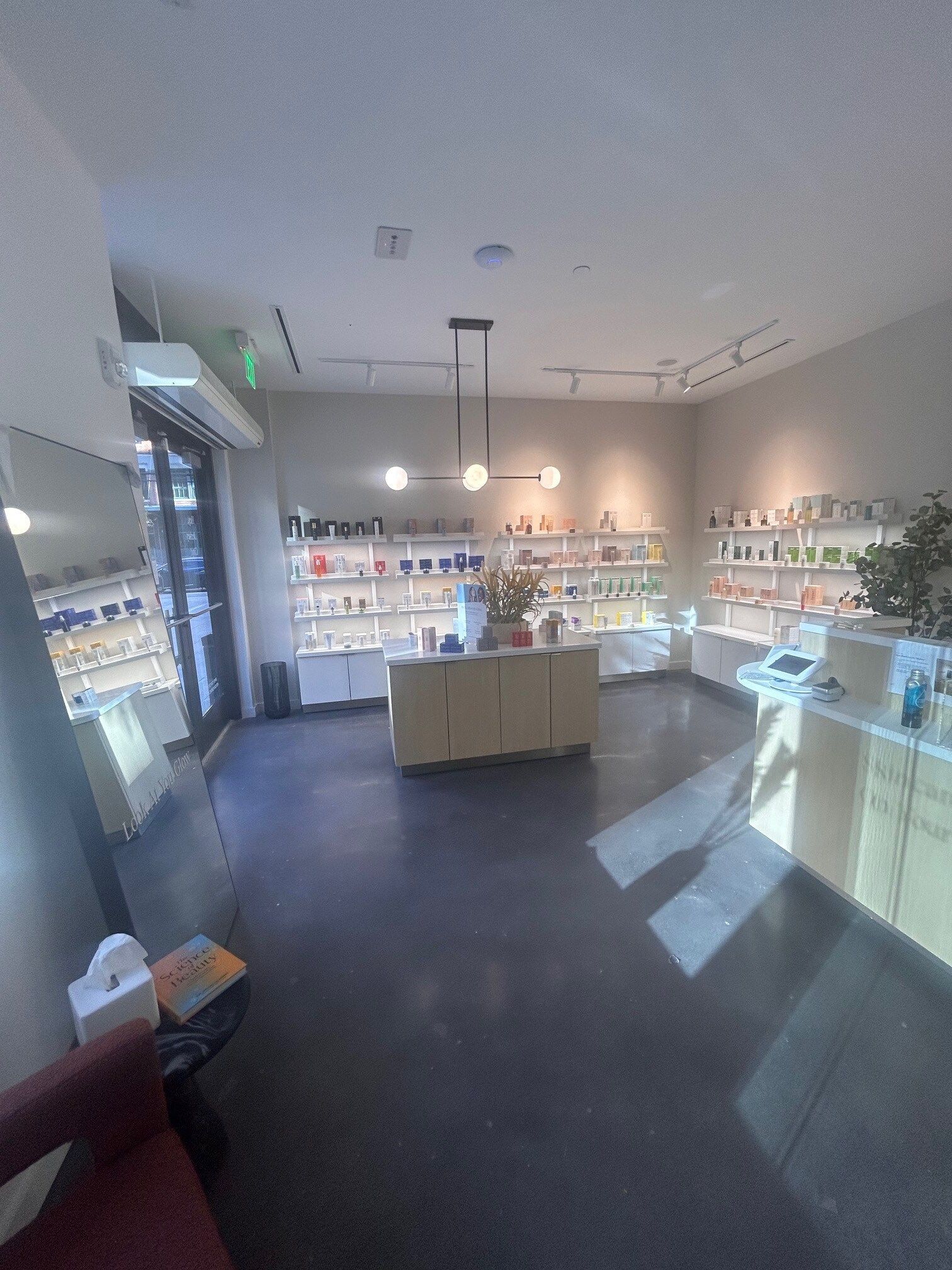 A large room with a lot of shelves and a counter in a store.
