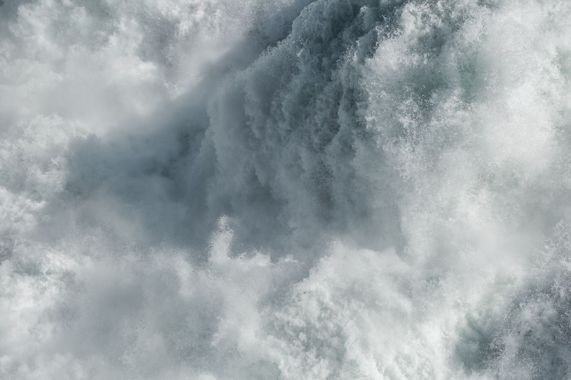 Close-up of foamy ocean waves crashing in gray-white water