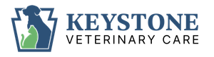 Logo for Keystone Veterinary Care featuring a blue keystone shape, a blue dog silhouette, and a green cat silhouette.