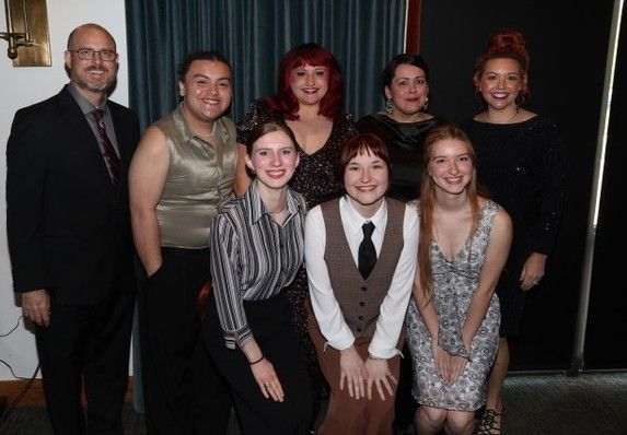 Group of six people posing and flashing the