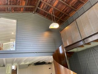 A modern interior featuring a wooden ceiling and a large pendant light — Channel Electrical In Swansea Heads, NSW