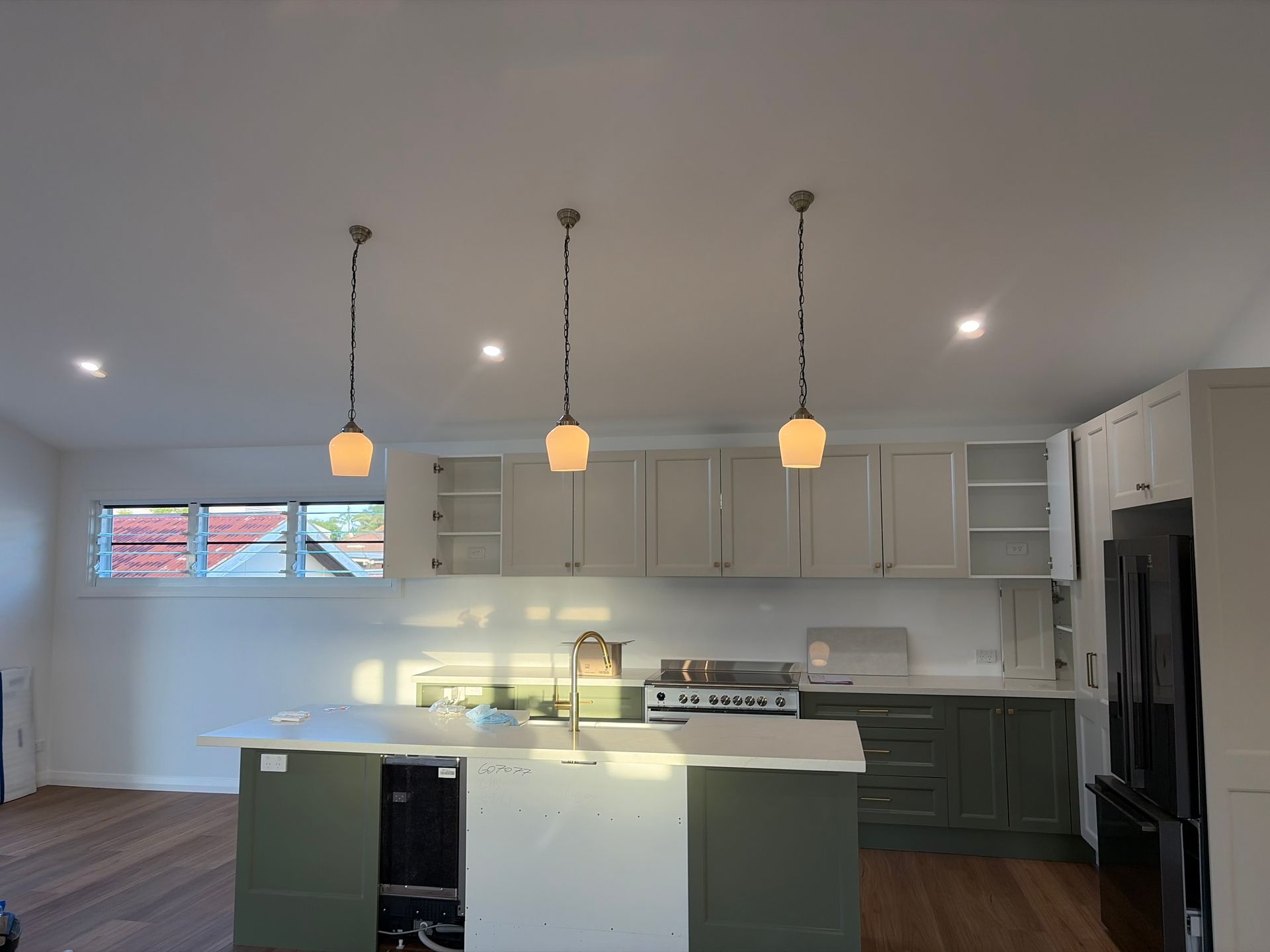 A modern kitchen with an island — Channel Electrical In Swansea Heads, NSW