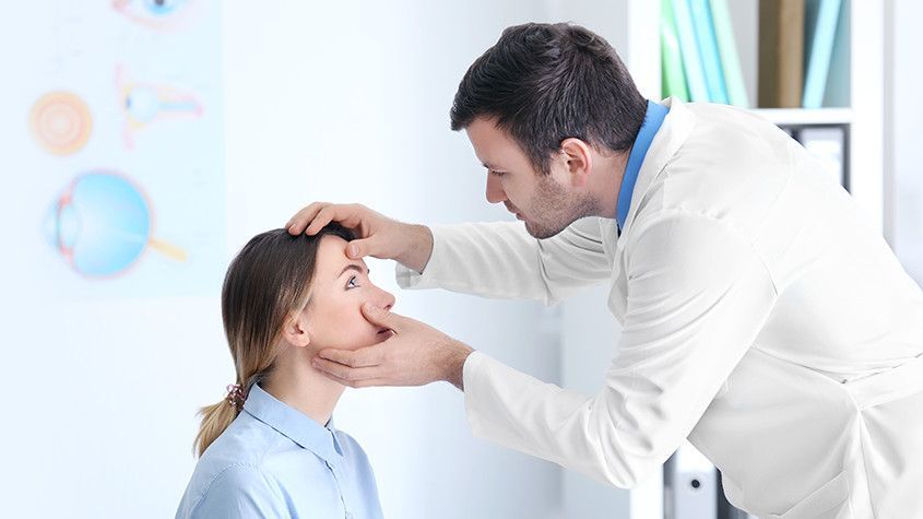 Doctor examining a patient’s eye in a bright clinic setting