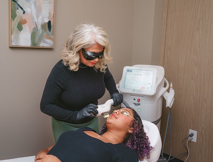 Clinician treating a patient with a laser device in a medical office