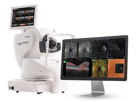 White robotic imaging system scanning a monitor showing multiple sample images, including colorful and grayscale displays