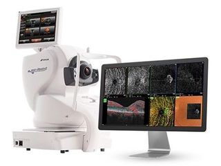 White robotic imaging system scanning a monitor showing multiple sample images, including colorful and grayscale displays